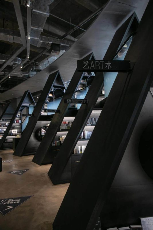 Books are placed in triangular shelves scattered high and low